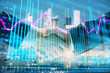 © Andrey - Double exposure of financial chart on cityscape background with two businessmen handshake. Concept of financial analysis and investment opportunities