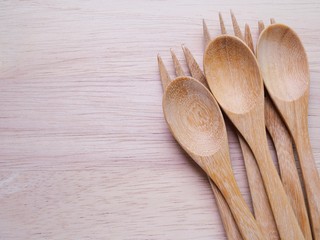 Wall Mural - Three pairs of wooden spoon and fork set on a cutting board with copy space