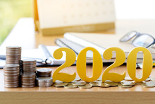 Word 2020 Put On Coins With Coins Stack On Desk .Savings New Year Concept.