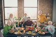 © deagreez - Photo of big family sitting hugging feast table holiday roasted turkey making portrait eight relatives wife husband multi-generation raise wine glasses in living room indoors