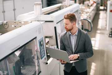 Manager checks machines at the factory. Inspector checks a factory.