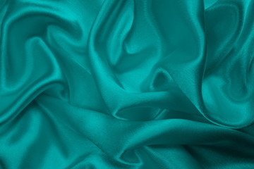 satin fabric lies on the surface in the form of delicate folds