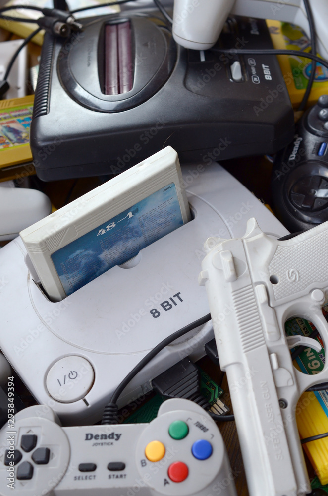 Pile of old 8-bit video game consoles and many gaming accessories like ...