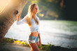 Travel vacation widescreen wallpaper - Beautiful young pretty blonde girl in bikini with white sand on perfect sport sexy body relax in sea of white sand paradise tropical Maldive beach at sunny day