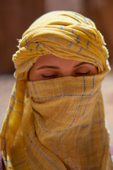 Wall Mural - Portrait of the woman with closed eyes and tied yellow berber tagelmust scarf. 