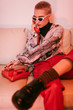 © Sergey Filimonov/Stocksy - Stylish woman in sunglasses speaking on retro phone