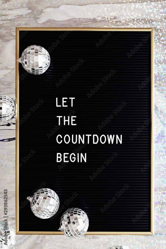Board letter saying Let the countdown begin and silver disco balls ...