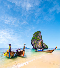 long boat on beautiful sand beach and tropical sea and blue sky on Poda island in Krabi,  Thailand,