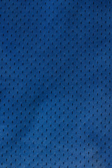 Sport Clothing Fabric Texture Background. Top View of Cloth Textile Surface. Blue football shorts. Copy Space. Seamless perforated mesh pattern material