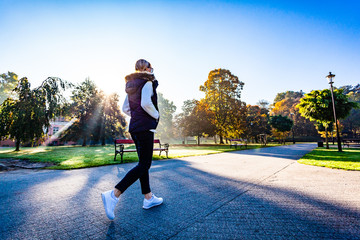 Wall Mural - middle-aged woman walking in city park