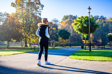 Wall Mural - middle-aged woman walking in city park