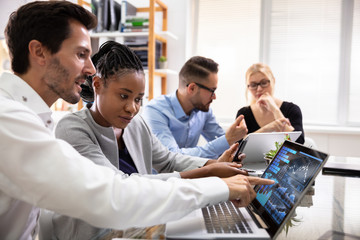 Poster - Group Of Businesspeople Examining Graph On Computer