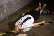 Crime scene imitation. Dead woman police officer lying on a floor..