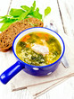 © kostrez - Soup with couscous and spinach in blue bowl on towel