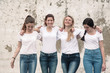 © Alena Ozerova - Group of diverse girls in tshirts and jeans over street wall