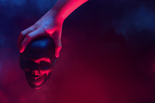 Ghost In Witch Of Devil Satan Hand Holding The Death Skull Head With Smoke Fog Background In Halloween Holiday Night Party Season Festival Concept