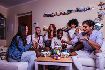 A group of young people celebrating and making party at home