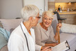 © Dragana Gordic - Friendly female doctor talking with old woman. Caring female doctor talks with senior female patient. Mature female doctor is consulting a senior patient.