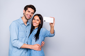 Sticker - Portrait of nice-looking attractive charming lovely cheerful cheery gentle sweet adorable couple holding in hands cell taking making selfie isolated on light white gray pastel color background