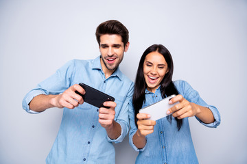 Poster - Photo of charming cute nice fascinating beautiful couple of two trendy people playing with each other some games in gamepad isolated white grey color background