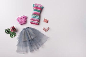 Wall Mural - Fashion spring outfit for girl. Knitting ress, tulle skirt, shoes, bouquet of flowers and accessories. Hand-made clothes for 11-inch doll.