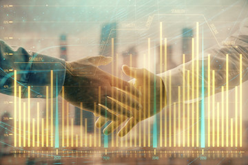 Double exposure of financial graph on cityscape background with two businessman handshake. Concept of stock market deal