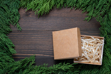 Wall Mural - A frame of fir branches and an open gift paper box. Christmas card blank.