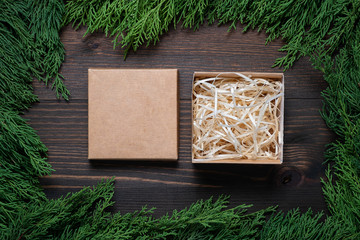 Wall Mural - A frame of fir branches and an open gift paper box. Christmas card blank.