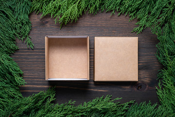 Wall Mural - A frame of fir branches and an open gift paper box. Christmas card blank.
