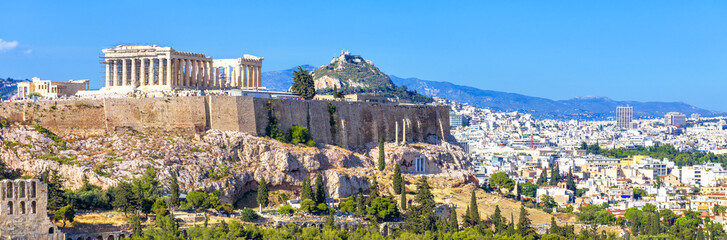 Wall Mural - Panoramic view of Athens, Greece. Acropolis hill rises above cityscape. Landscape of old Athens city with Ancient Greek ruins. Skyline of Athens in summer.