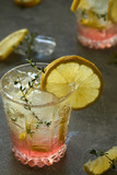 Fototapeta Kuchnia - Cool drink with lemon and thyme in a glass on a gray background