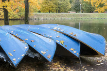 Autumn Landscape. Covered With Yellow Leaves Boats Lie On The Shore Of Park Lake.
