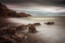 A High Outgoing Tide And A Long Exposure At Bracelet Bay On The Gower Peninsula In Swansea, South Wales, UK