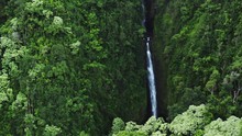 Aerial View Of Tropical Waterfall Flowing In Lush Green Jungle Forest