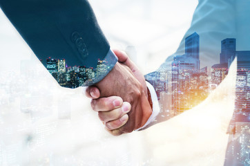 Wall Mural - Welcome. double exposure of business man partner handshake with during sunrise and cityscape background, digital communication technology, investment, negotiation, partnership and teamwork concept