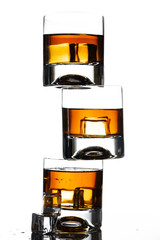 Canvas Print - glass of whiskey with ice cubes