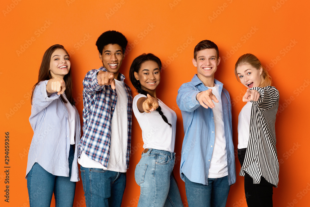 Happy teenagers pointing fingers at camera and smiling - obrazy, fototapety, plakaty 
