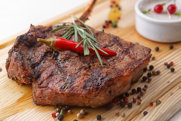 Wall Mural - Meat steak with sauce on a wooden board