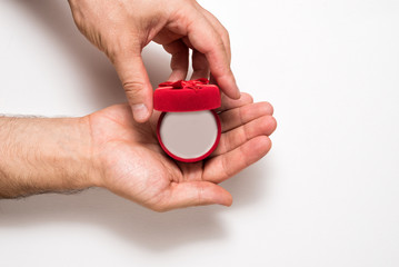 Wall Mural - Empty open red jewelry box in a male hands. Present. White background. Top view