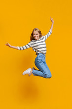 Happy Teenage Girl Jumping In Air, Pretending She Is Flying
