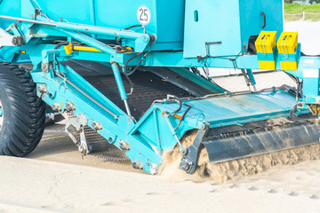 Tractor cleaning sand in South beach in Miami