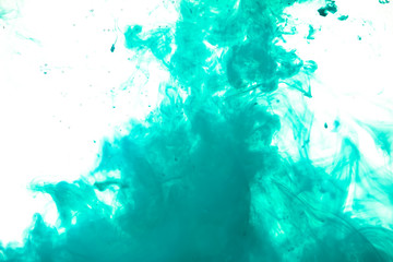 Poster - colorful blue ink isolated on white background, cloud of paint swirling in water, liquid dynamic abstract background