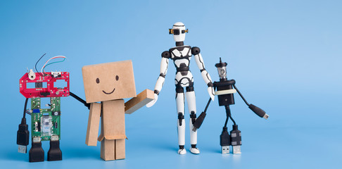 four different handmade robots on blue background