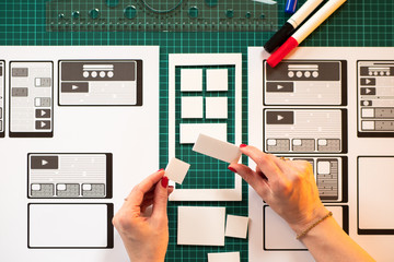 Poster - the girl works as a designer of mobile applications. the designer lays out the details of the applic