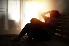 Desperate Man In Silhouette Sitting On The Bed With Hands On Head , Headache After Weak Up