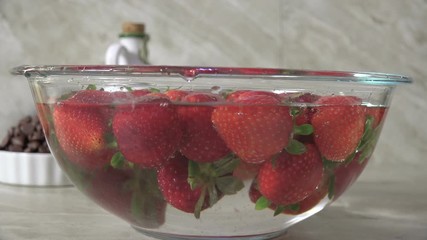 Sticker - Rinsing fresh strawberries in a bowl of water