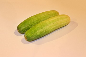 two small green cucumbers