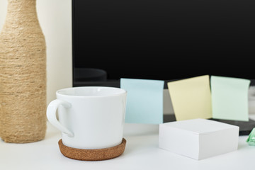 Wall Mural - Modern workspace background. Workplace with a cup of coffee, office supplies and sticky notes on table