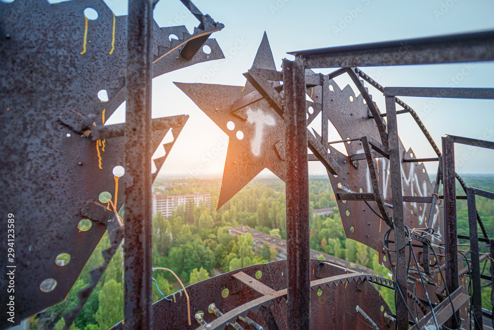 Soviet Union iron coat of arms in the dawn rays on the roof of a multi ...