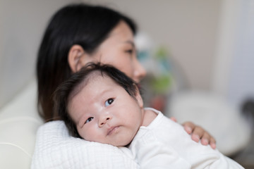 portrait of asian mother and baby relaxing